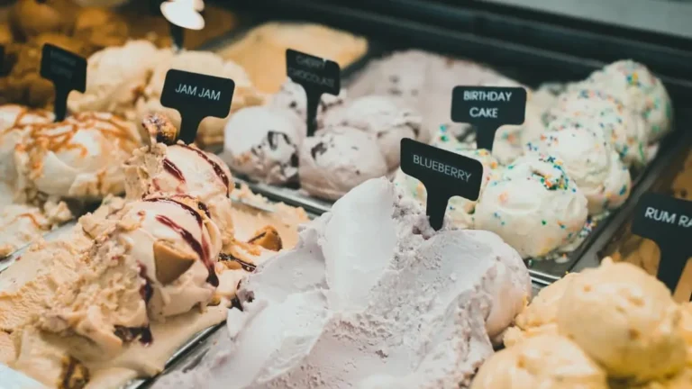 Ice cream display case with labeled flavors: blueberry, birthday cake, cherry chocolate and more